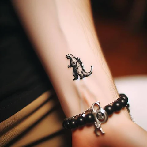 Blending With The Skin Small Godzilla Tattoo With Fabulous Outlines