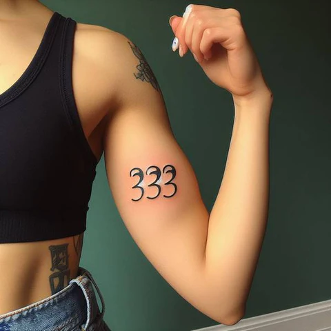 11 Thrilling 333 Tattoo Ideas To Enhance Your Creative Prowess! 7 Cursive Flamboyance Stylish 333 Tattoo On Bicep